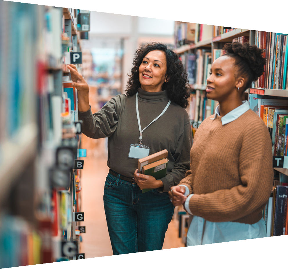 Student in a library looking at books