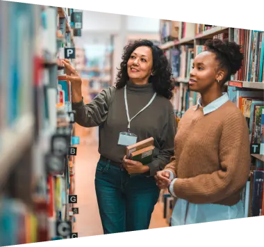Student in a library looking at books