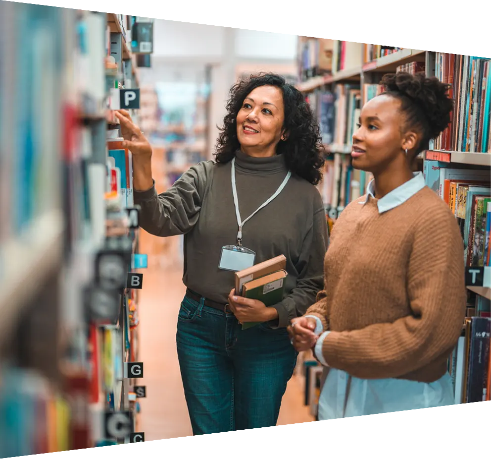 Student in a library looking at books