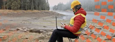 Man using laptop in remote area