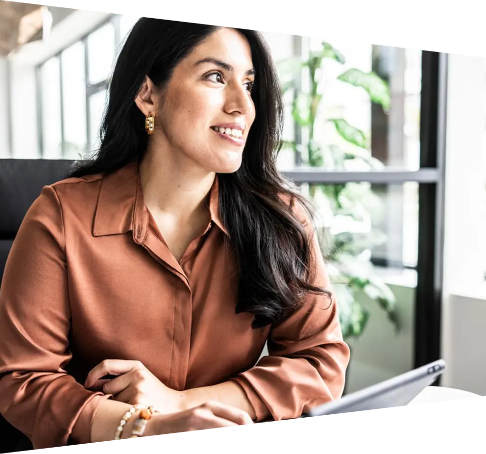 Young businesswoman looking out of the window in a modern office