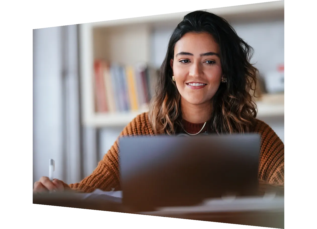 Student sitting in library using a tablet