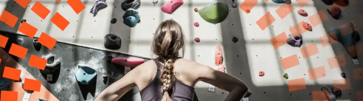 A woman looking at the wall feeling stuck and choosing where to go first