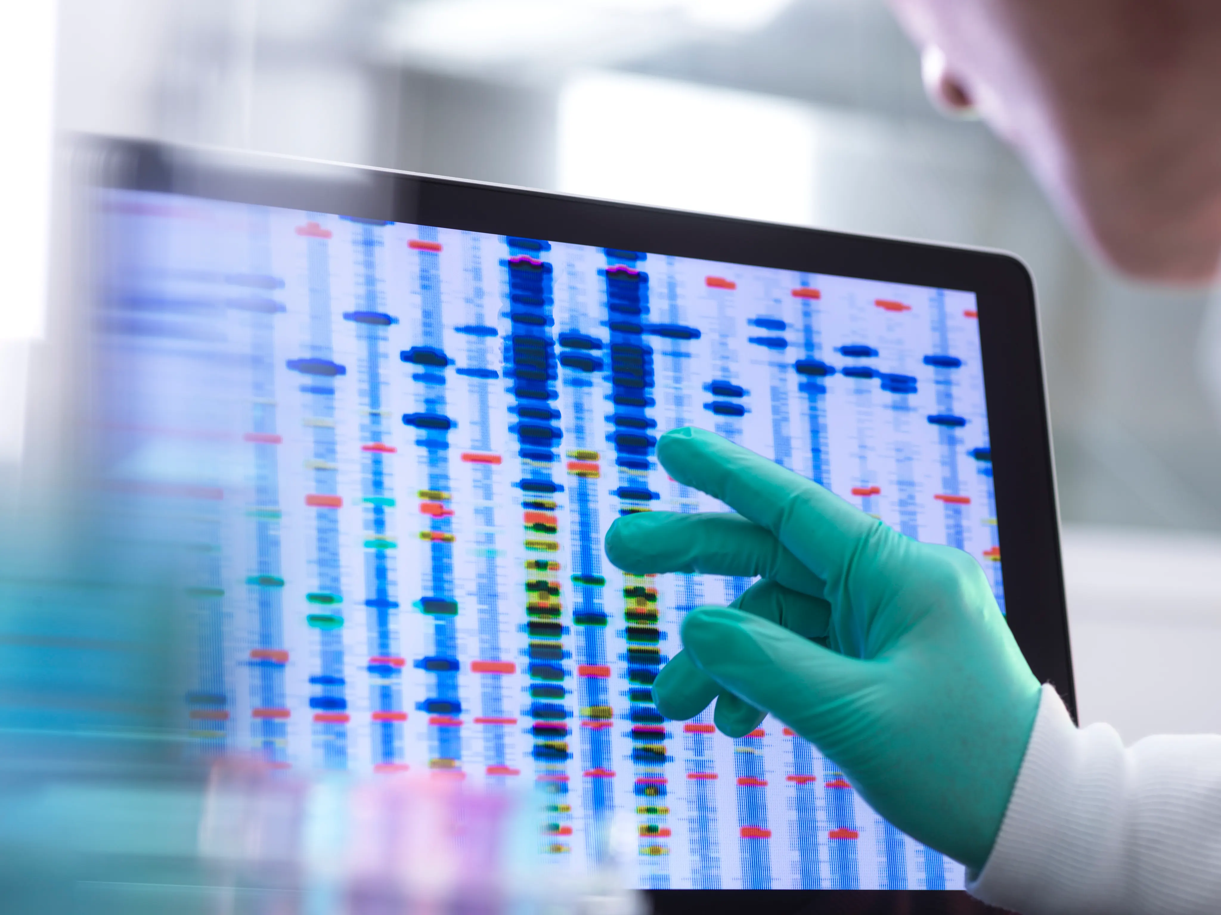 Scientist examining DNA (deoxyribonucleic acid) results on a screen during an experiment in the laboratory.