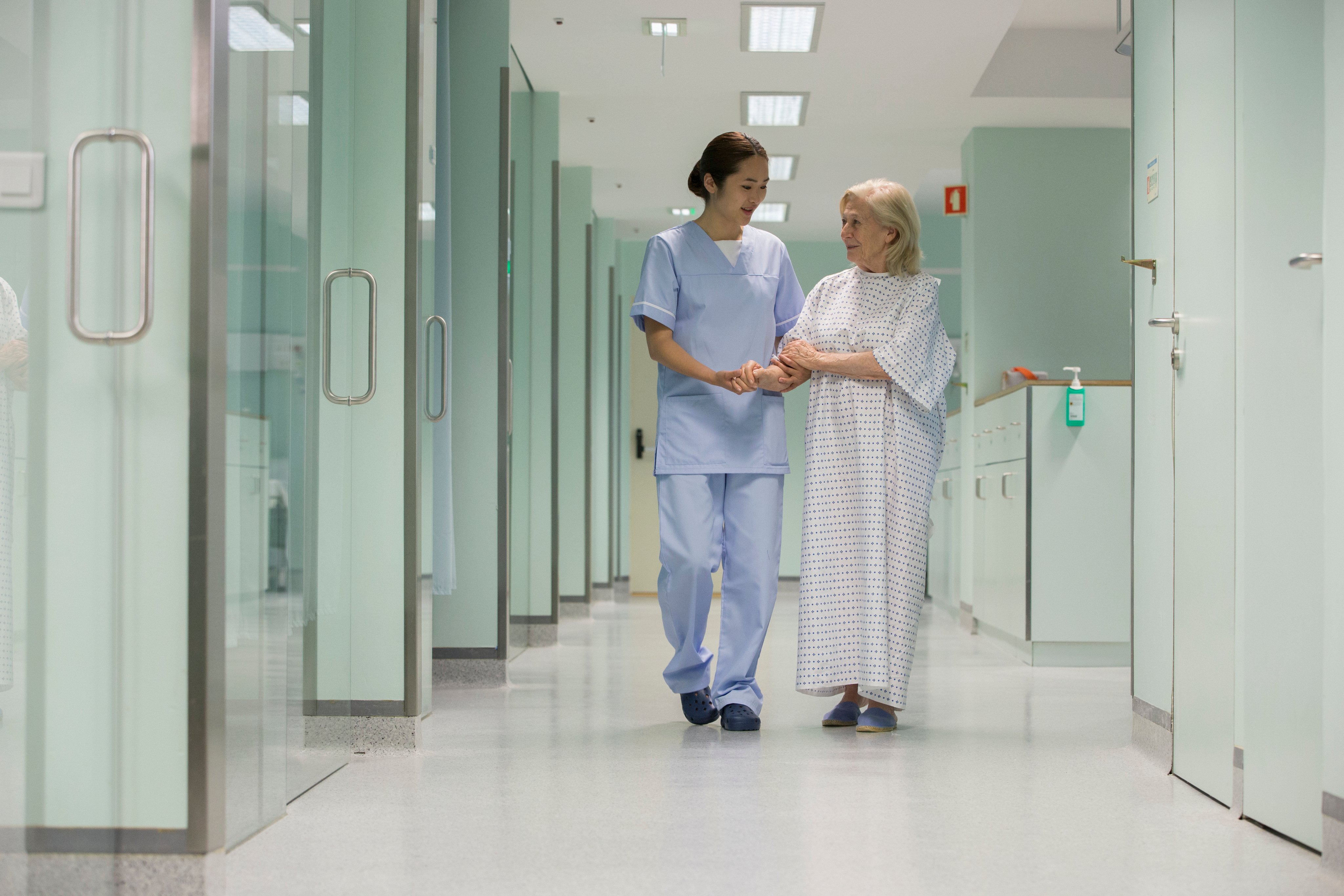 Nurse talking with patient in hallway