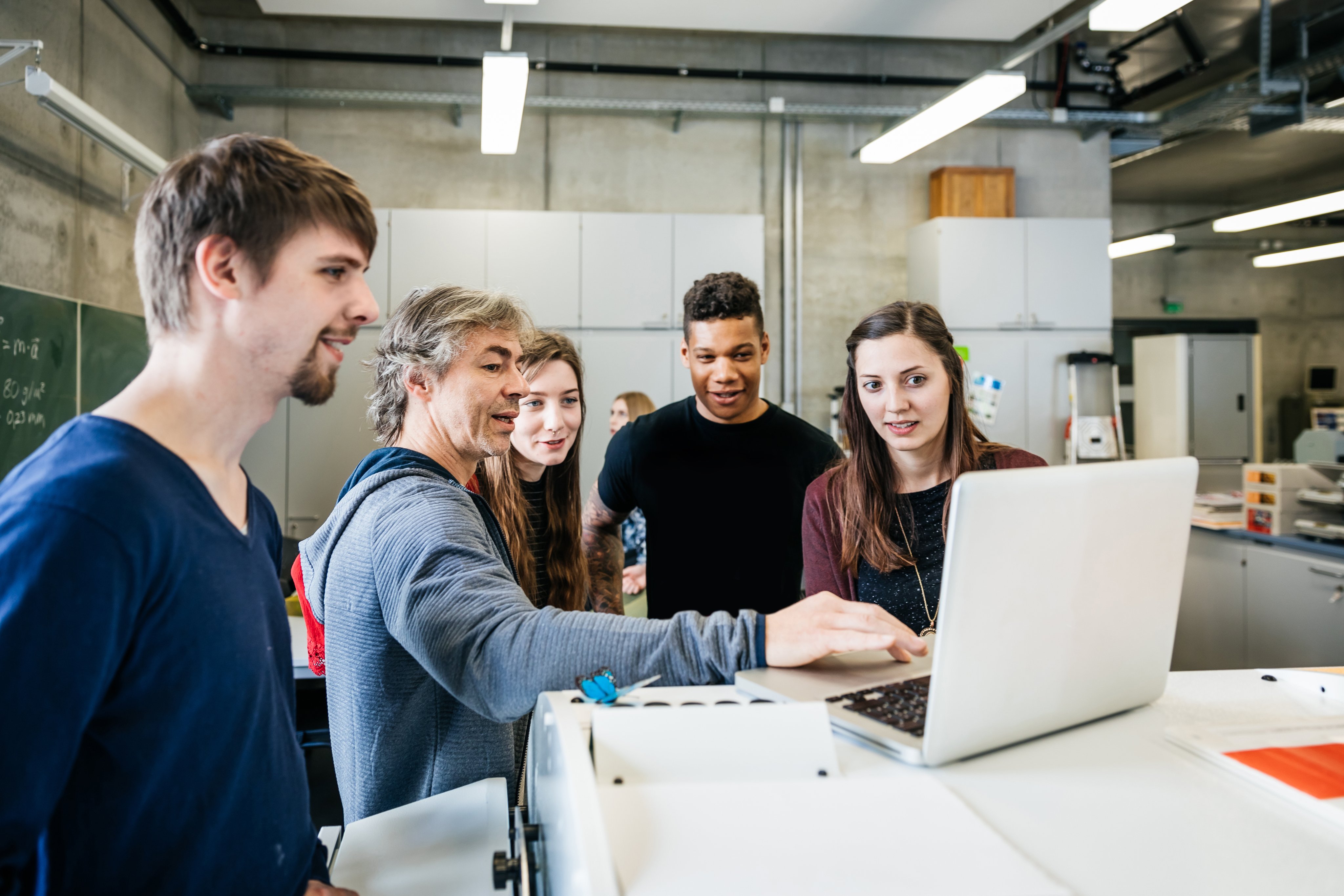 University lab technician talking with students