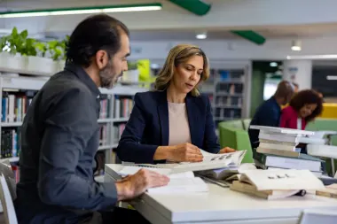 post graduate students studying together at the library