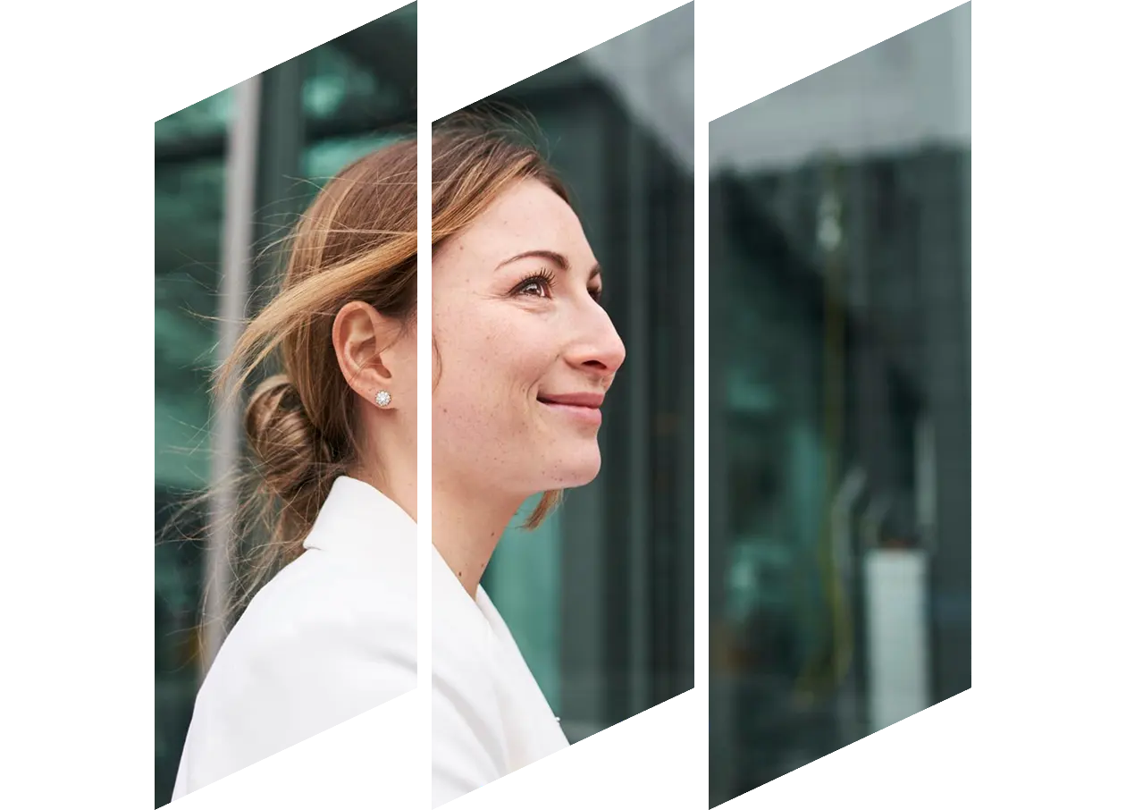Smiling young businesswoman in front of a building
