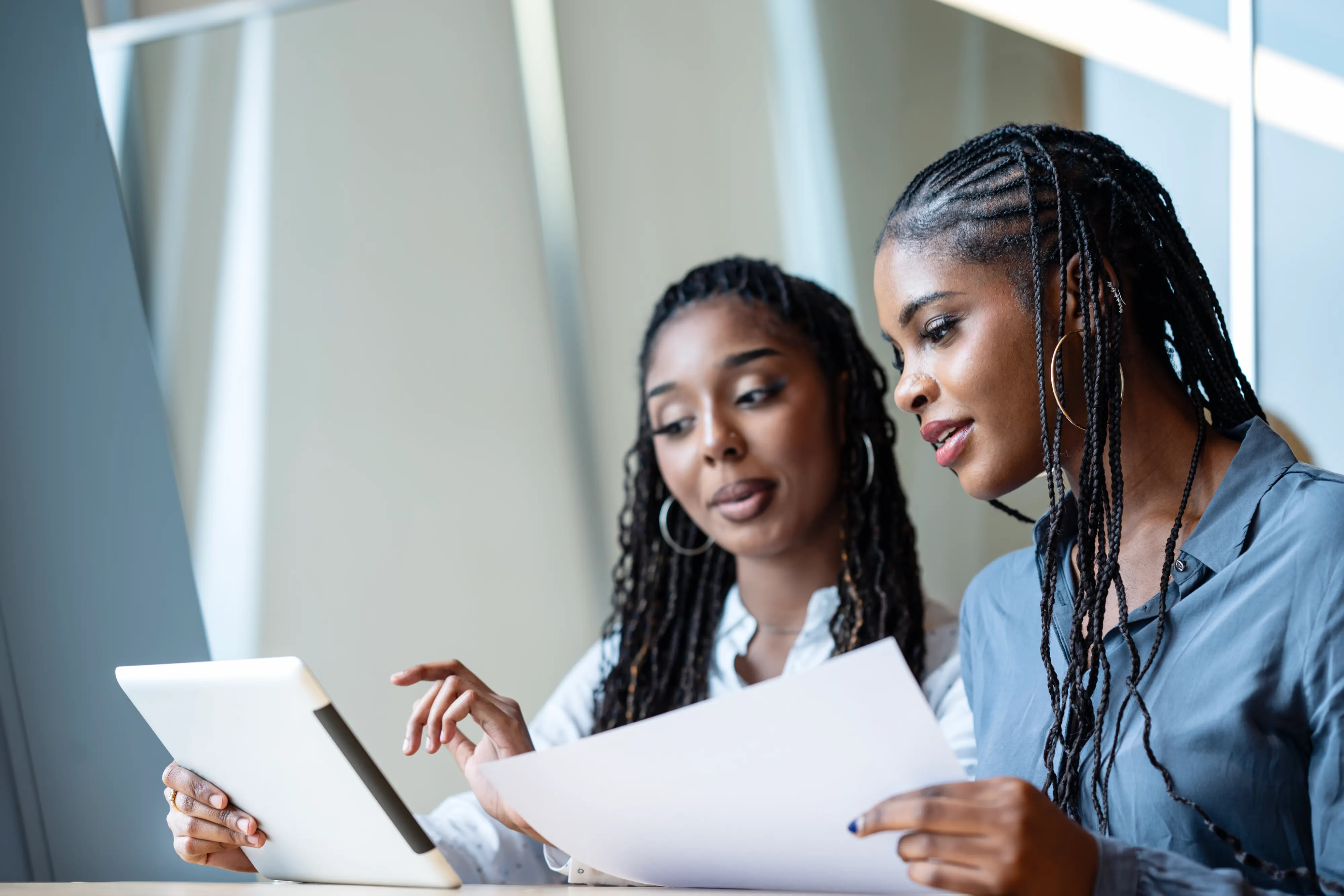 Two business woman discussing results