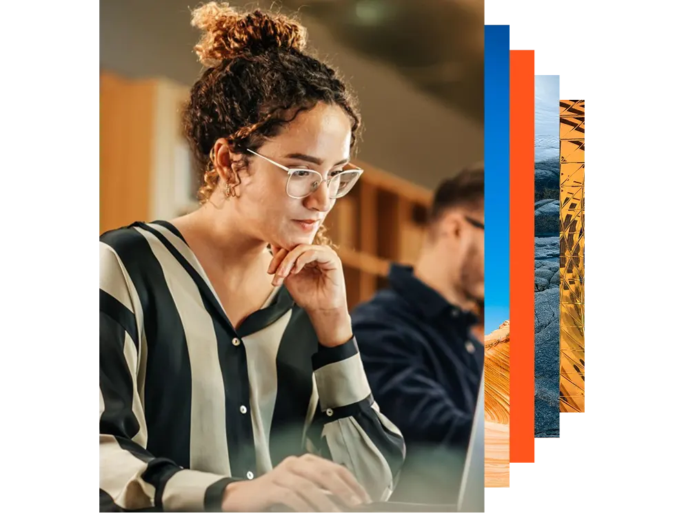 Enthusiastic Hispanic Young Woman Working on Computer in a Modern Office