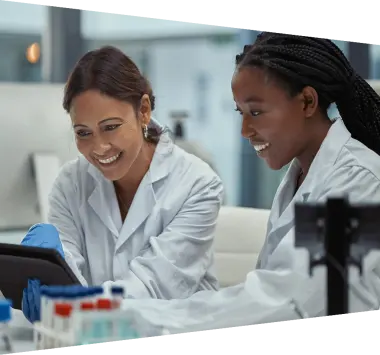 Two scientists working together on a digital tablet in a lab