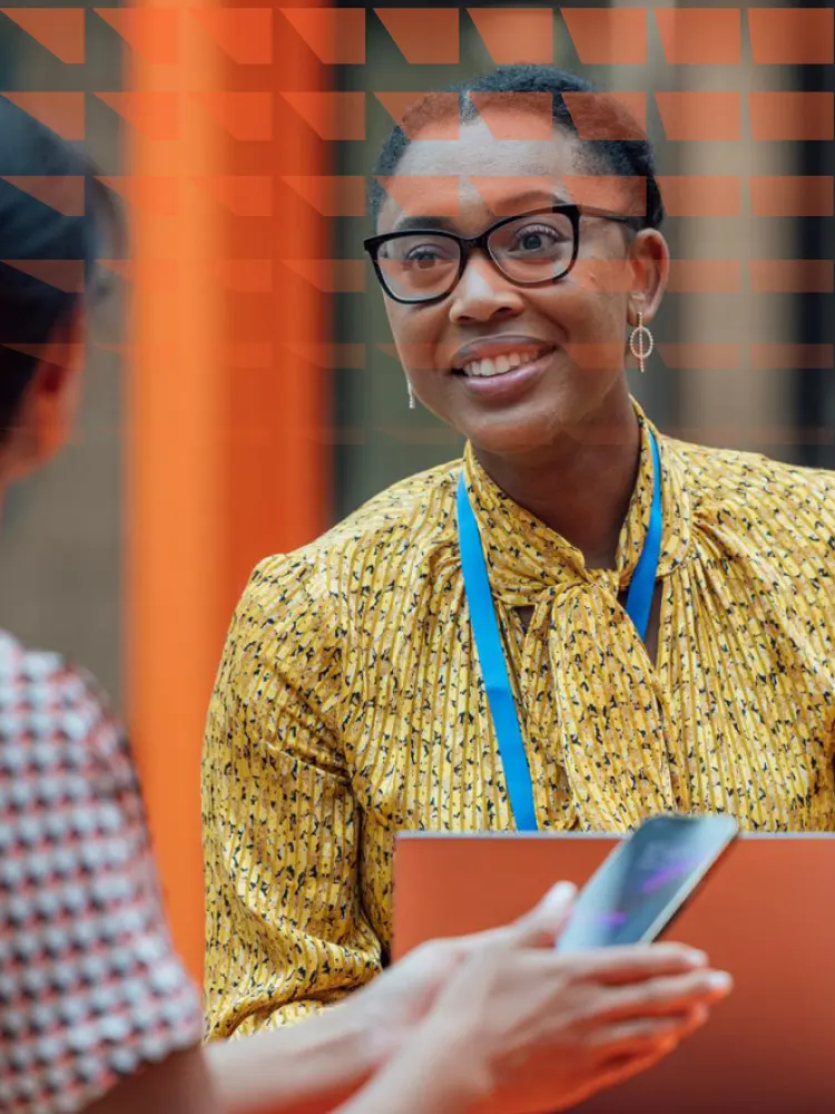 Two female librarians sitting at a table, having a discussion