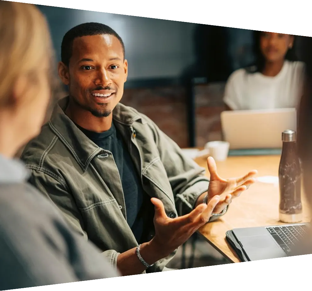 Businessman explaining strategies to colleagues in meeting at office