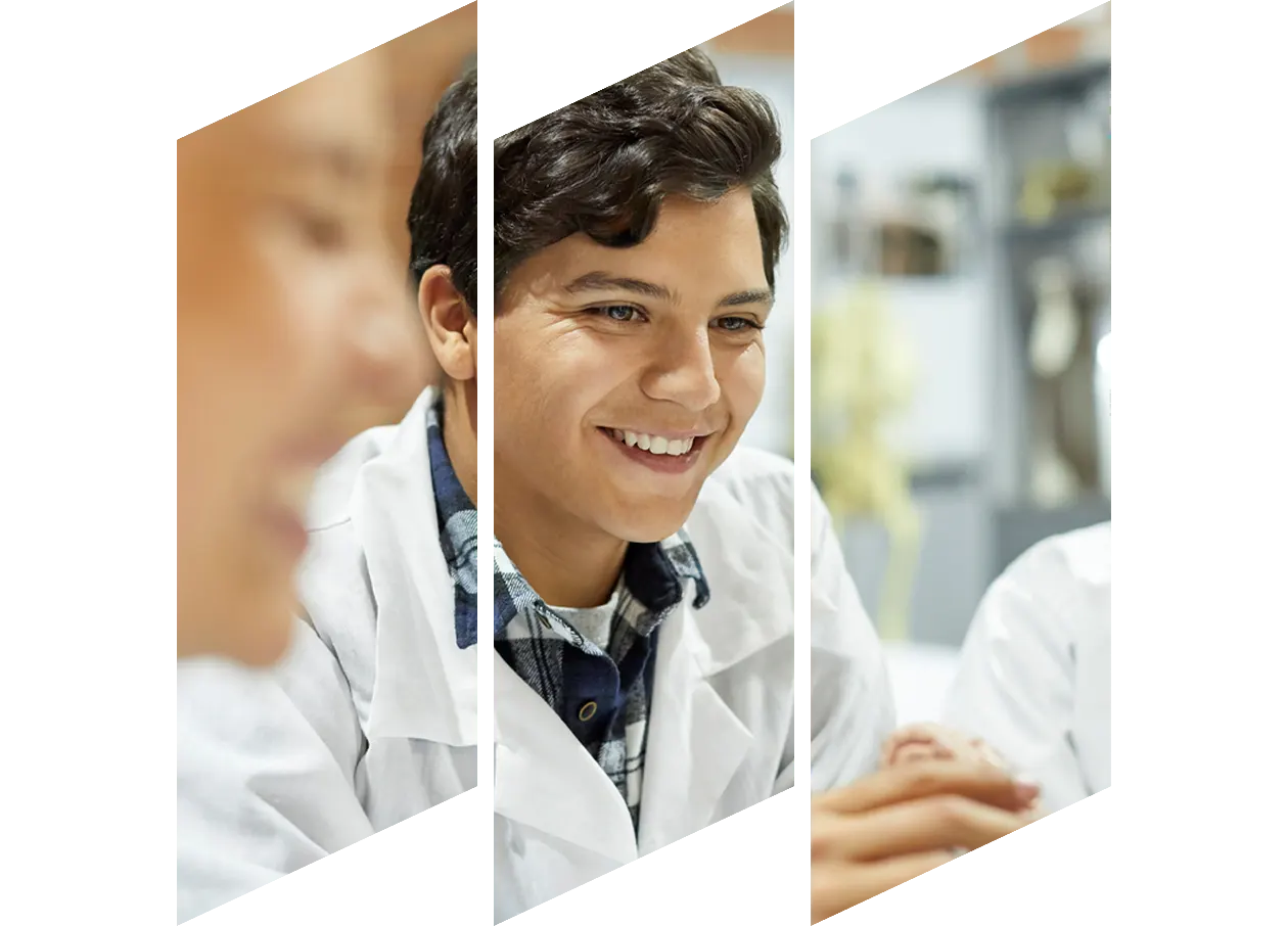 A man with glasses smiling broadly.