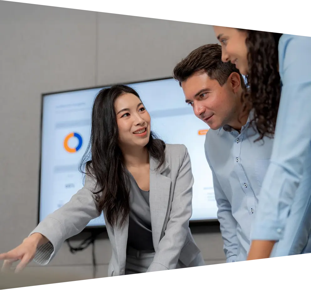 Professional business team analyzing annual sales data on a monitor