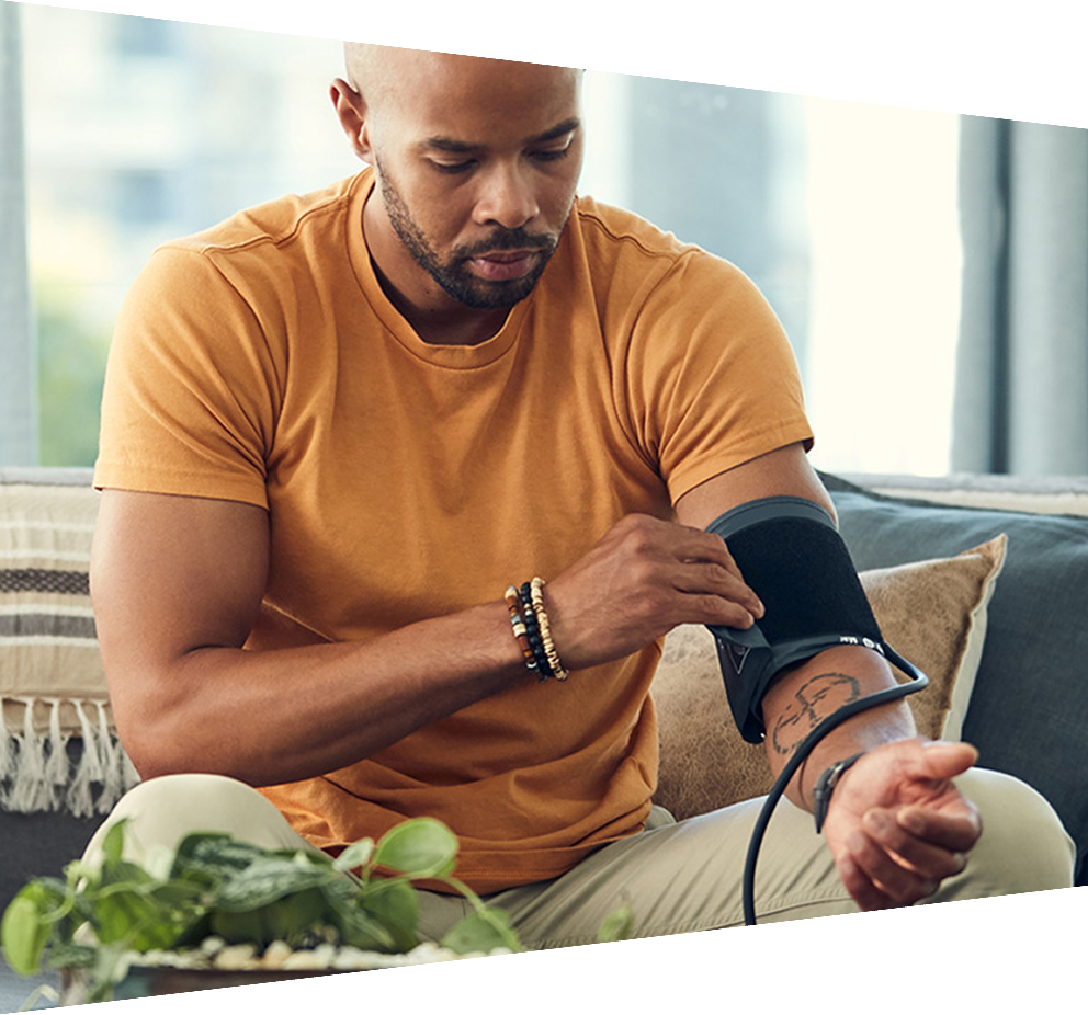 Man taking blood pressure at home