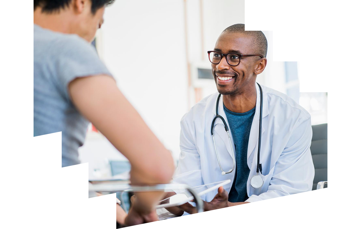 Happy male doctor showing results to patient in hospital
