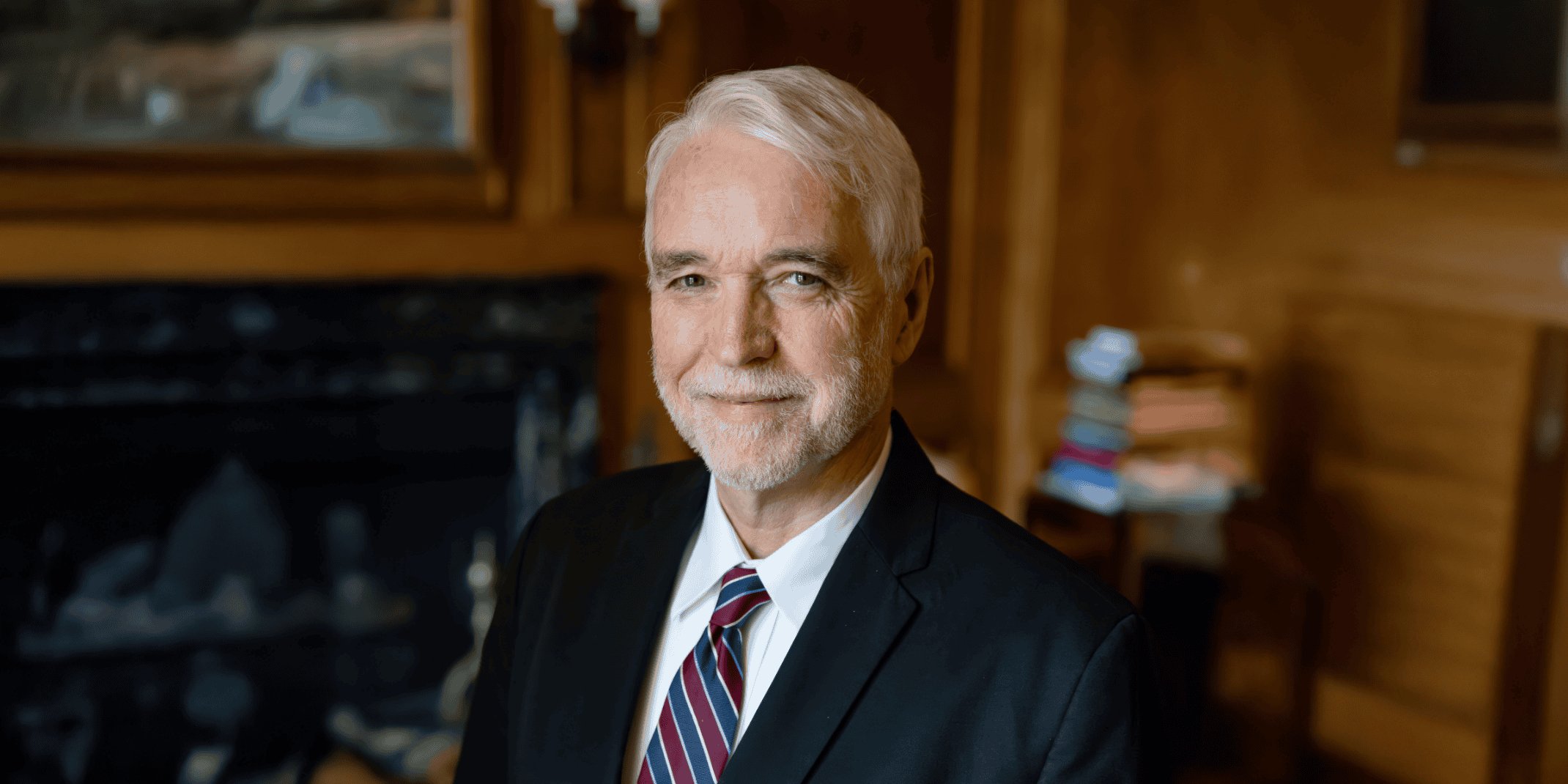 Photo of Dr Tim Killeen, President of the University of Illinois System, on a decorative background