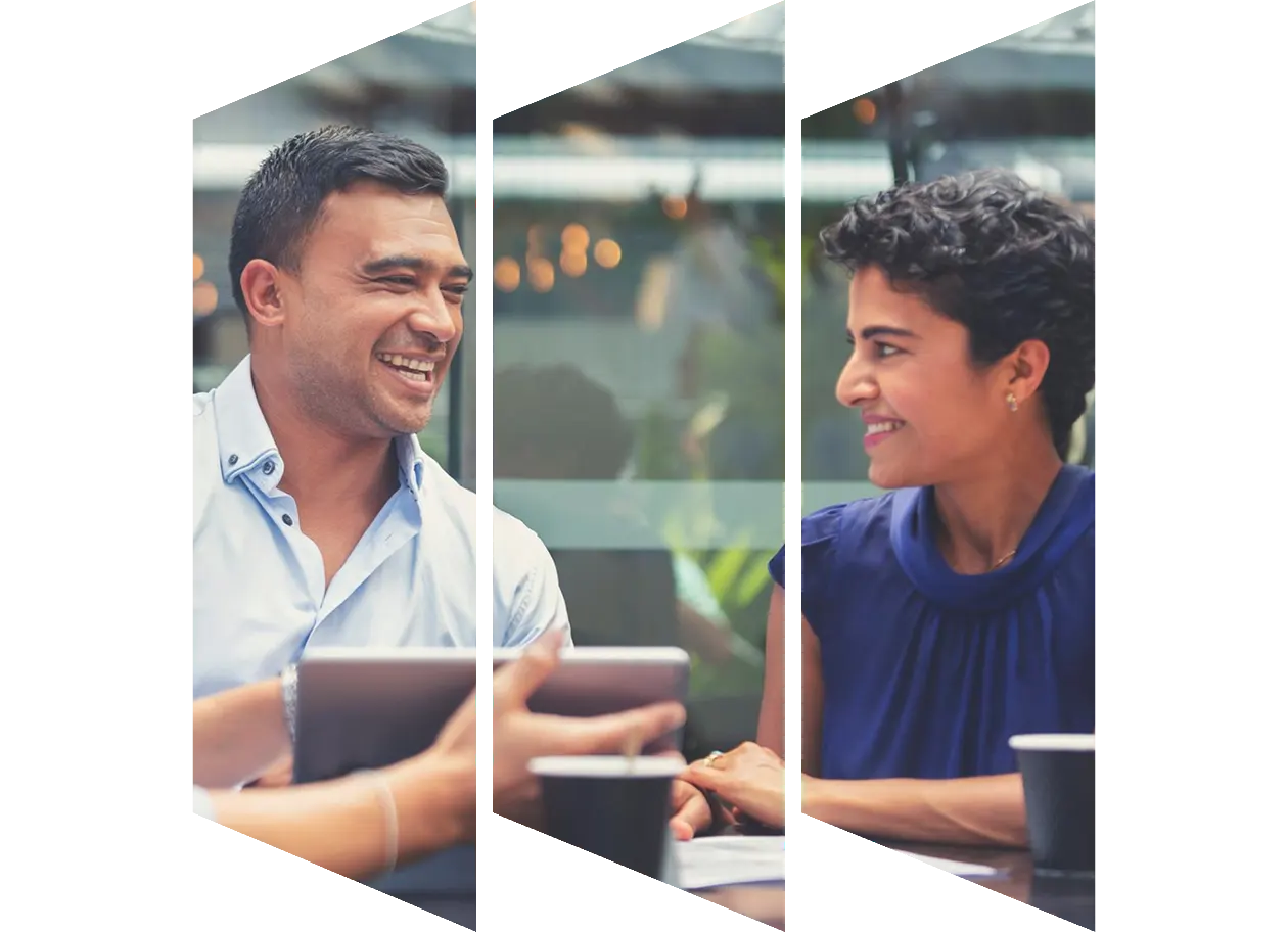 Colleagues looking at a laptop discussing something