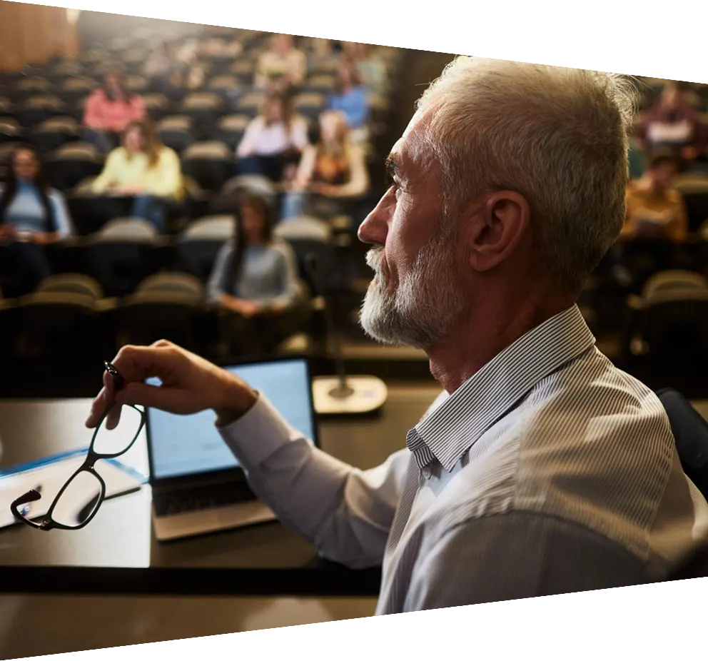Thoughtful mature professor on a class at lecture hall