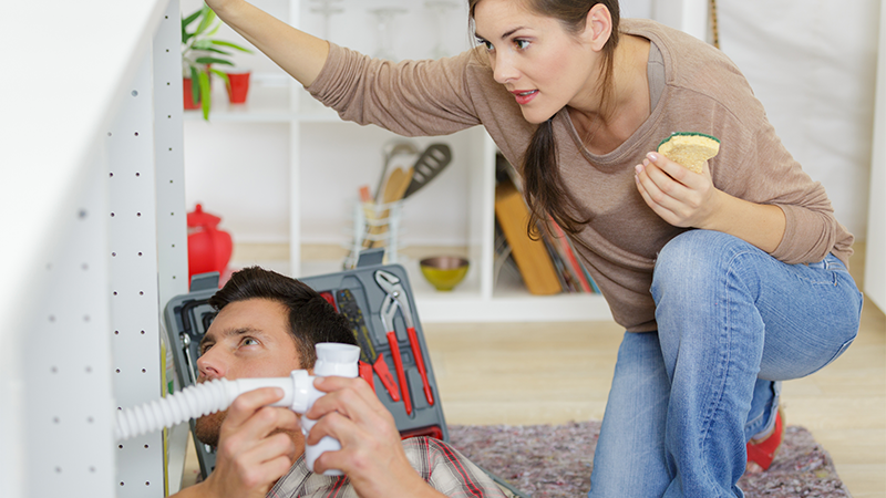 En mann og en dame med verktøy i hendene ser rådville på hverandre.