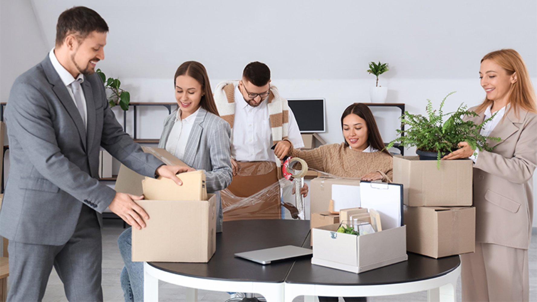 Ansatte i et kontorlandskap som pakker ut av esker