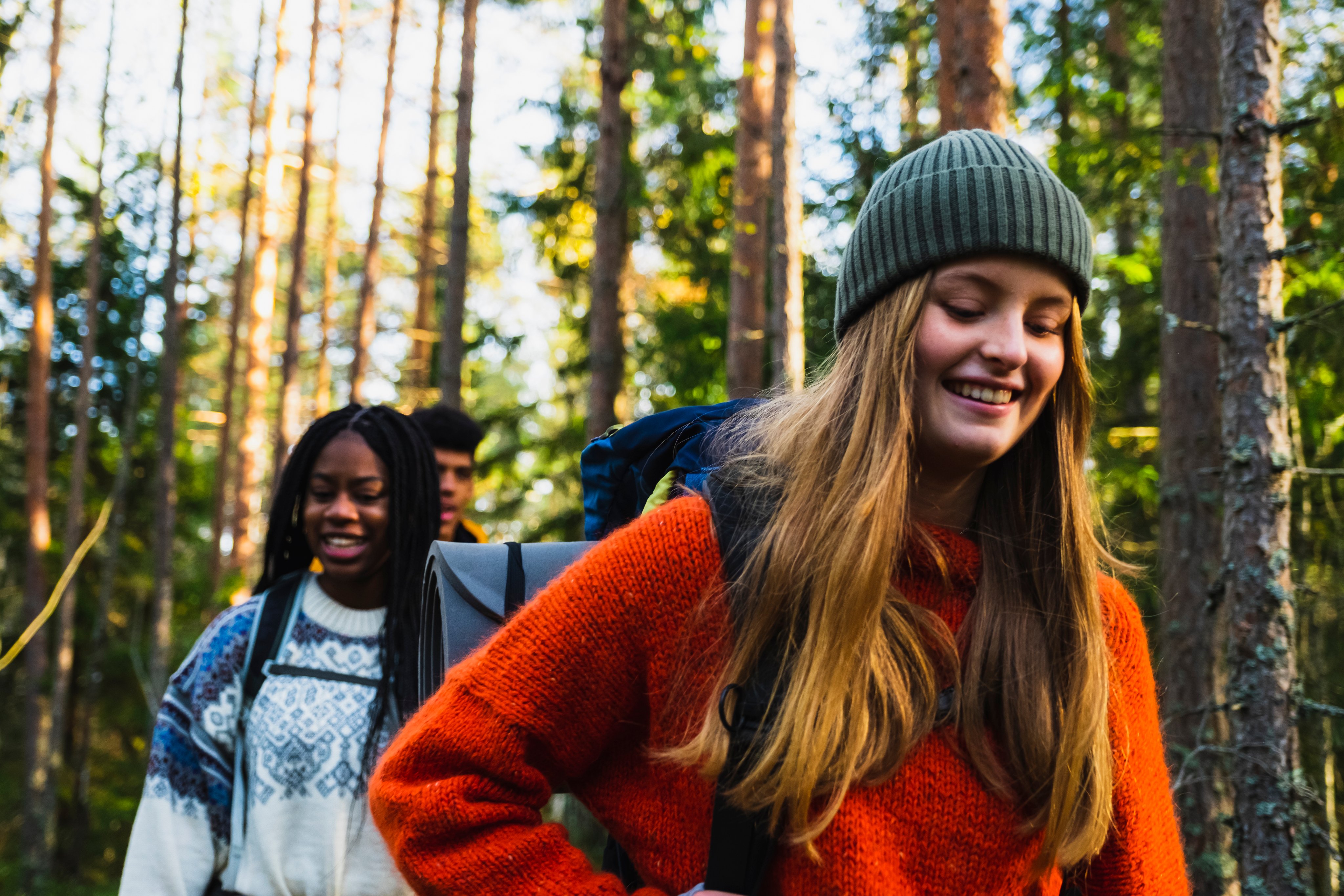 Tre venner er ute i skogen og går på tur sammen.