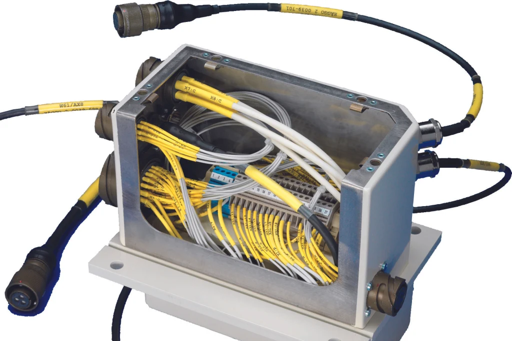Armoured vehicle showing cable assemblies linking onboard equipment and mission systems.