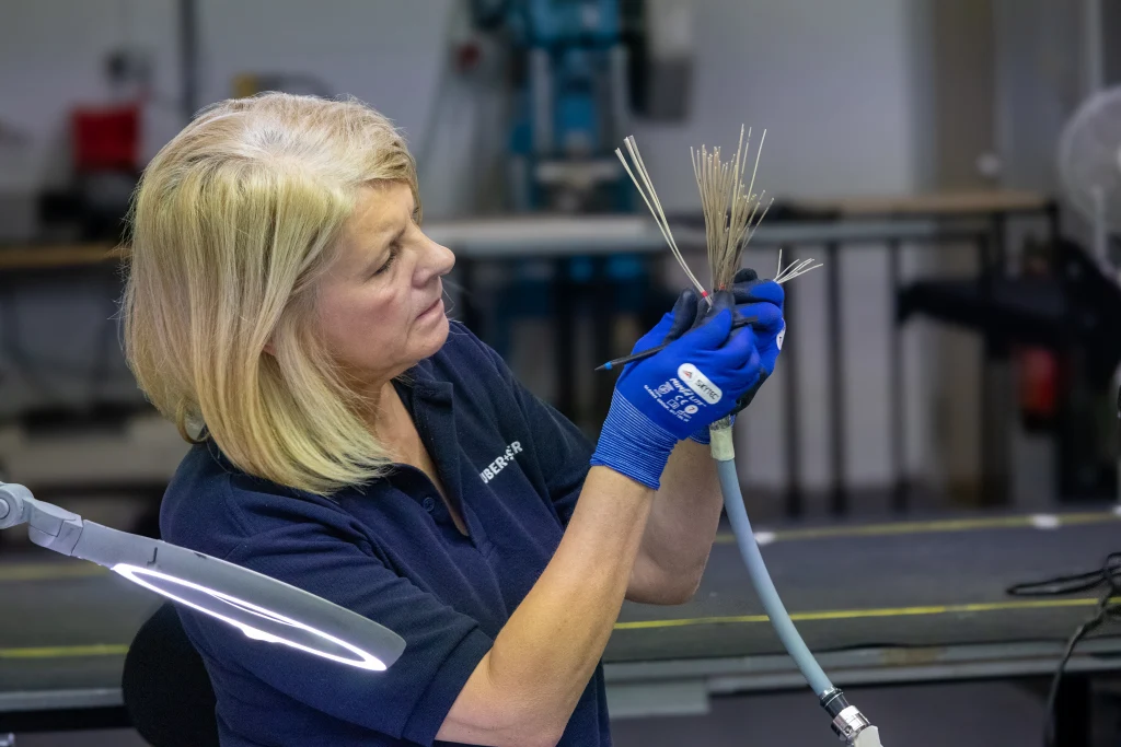 One of HUBER+SUHNER Phoenix Dynamics highly trained operators assembles safety critical wiring system One of HUBER+SUHNER Phoenix Dynamics highly trained operators assembles safety critical wiring system