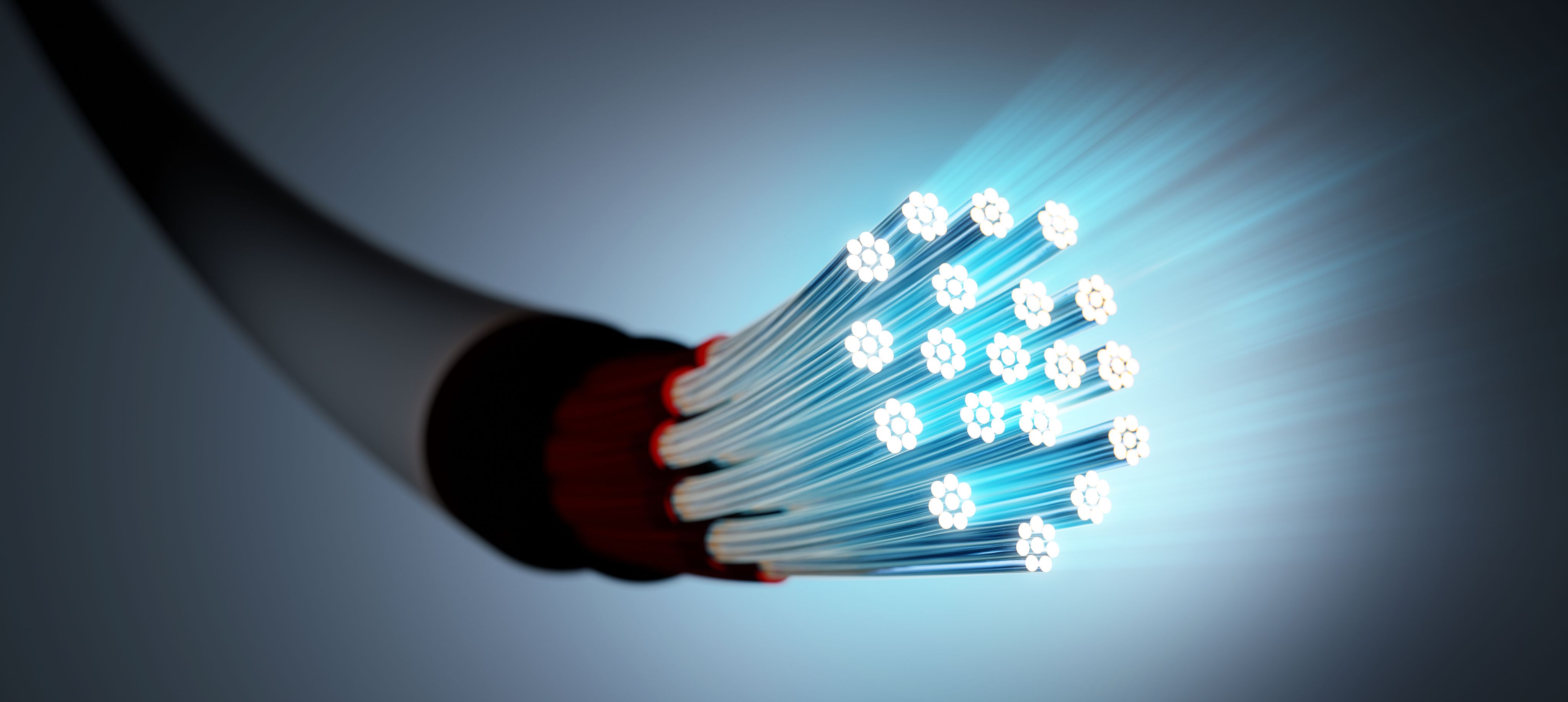 Glowing fiber optic cable strands transmitting data, symbolizing high-speed connectivity and advanced optical communication technology