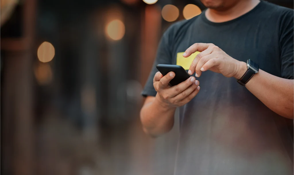 Closeup: Man using mobile phone at street night. Closeup: Man using mobile phone at street night.