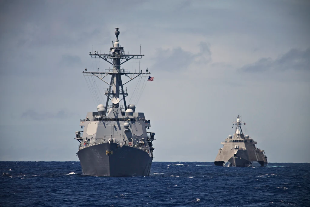 Two naval warships at sea with advanced communication and radar equipment. Two naval warships at sea with advanced communication and radar equipment.