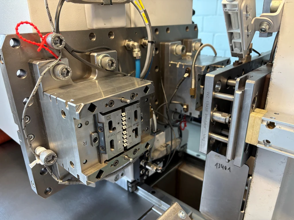 Rotary turntable unit for micro injection molding Close-up of a precision injection moulding tool mounted in a micro injection moulding machine for manufacturing small plastic components.