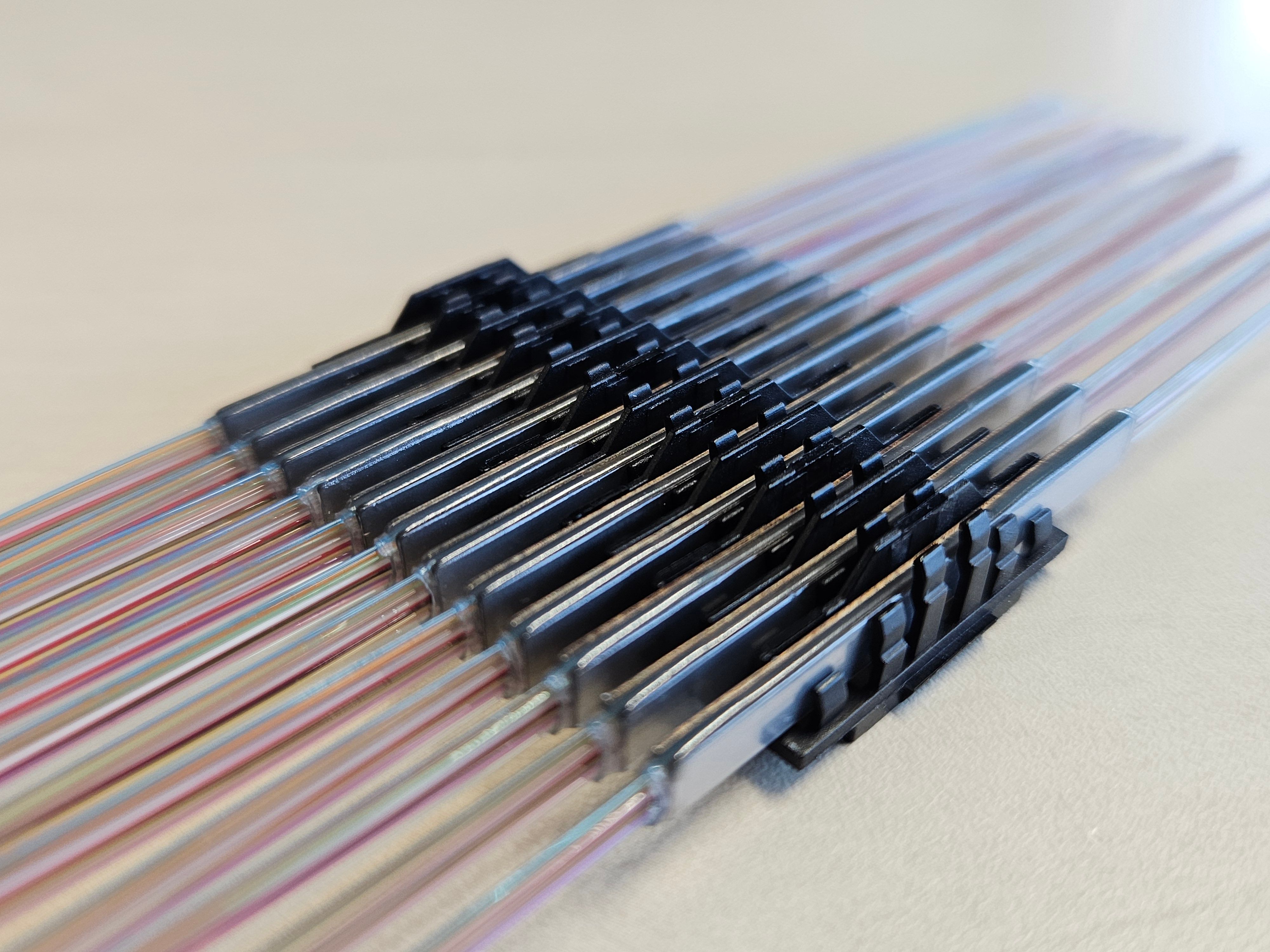 Ribbon fiber splice protectors placed on optical fibers for FTTH and telecom networks