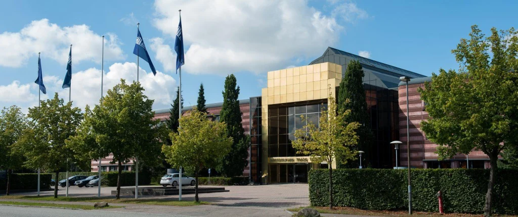 Office building with trees and flags in front of it