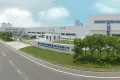 Modern industrial facility with white buildings, gated entrance, guardhouse, parked cars, and sign for HUBER+SUHNER Changzhou under a blue sky.