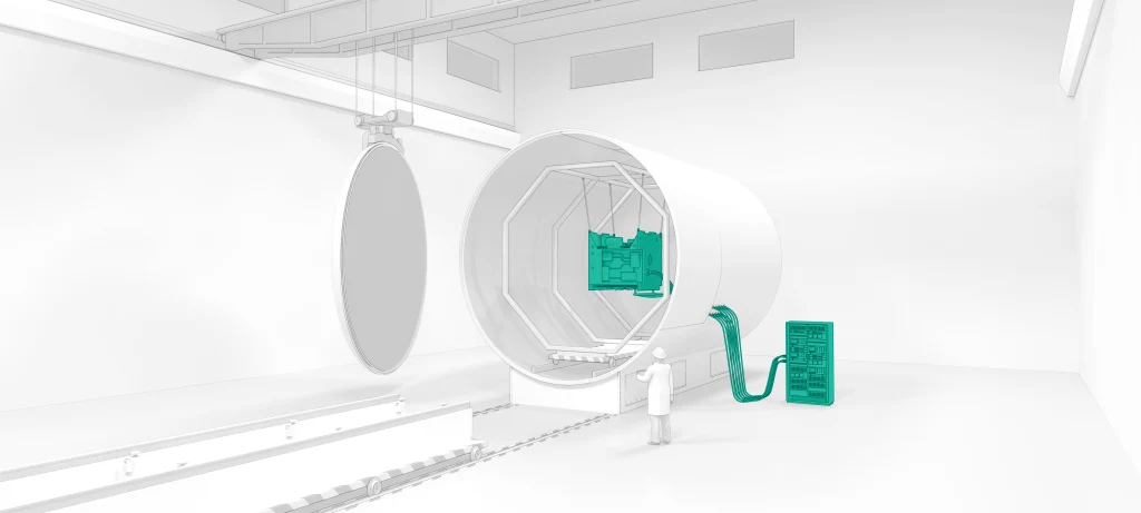 Industrial test chamber with connected equipment, control system and a technician standing nearby
