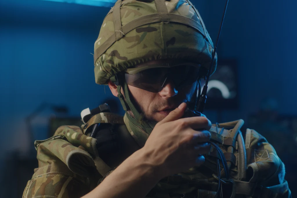 Medium close-up of a soldier talking into a walkie-talkie Medium close-up of a soldier talking into a walkie-talkie