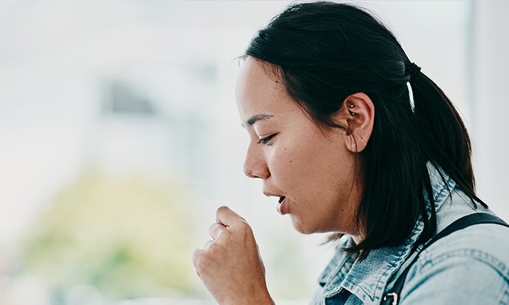 How to get rid of a dry cough Woman Coughing Covering Her Mouth with Hand