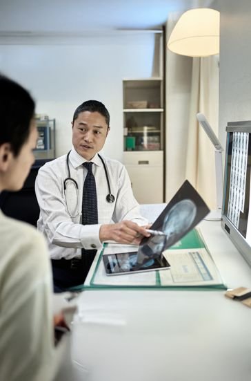 Clinical oversight team monitoring proton therapy outcomes
