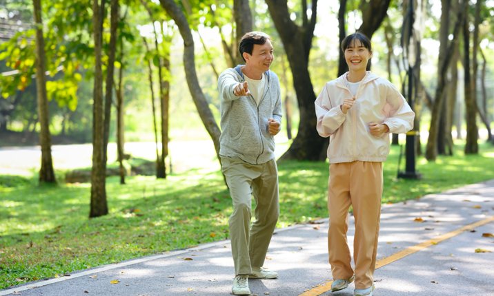 How to maintain good heart health People Exercising Walking on Paved Trail Outdoors