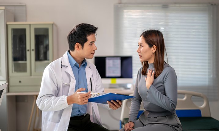A doctor is talking to a woman in a hospital room - in text image