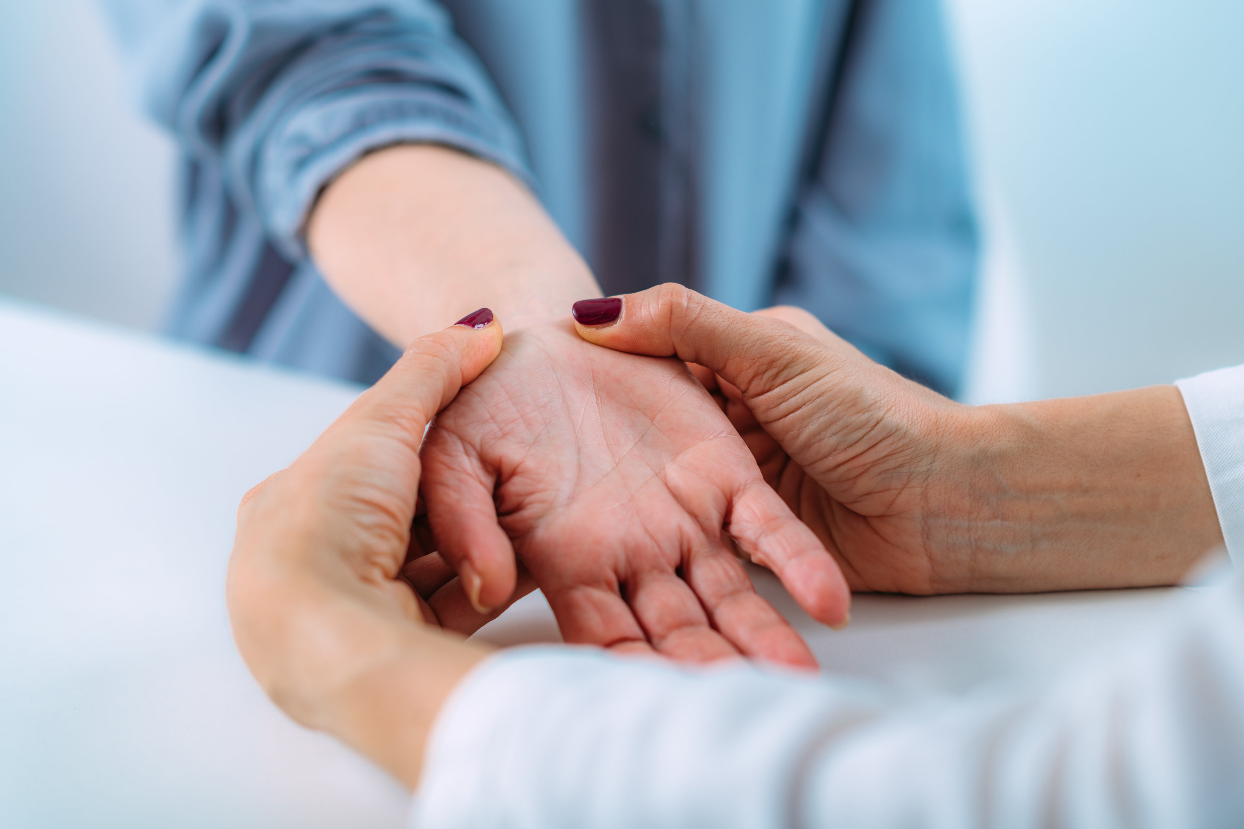 An occupational therapist assessing and treating a patient with wrist injury
