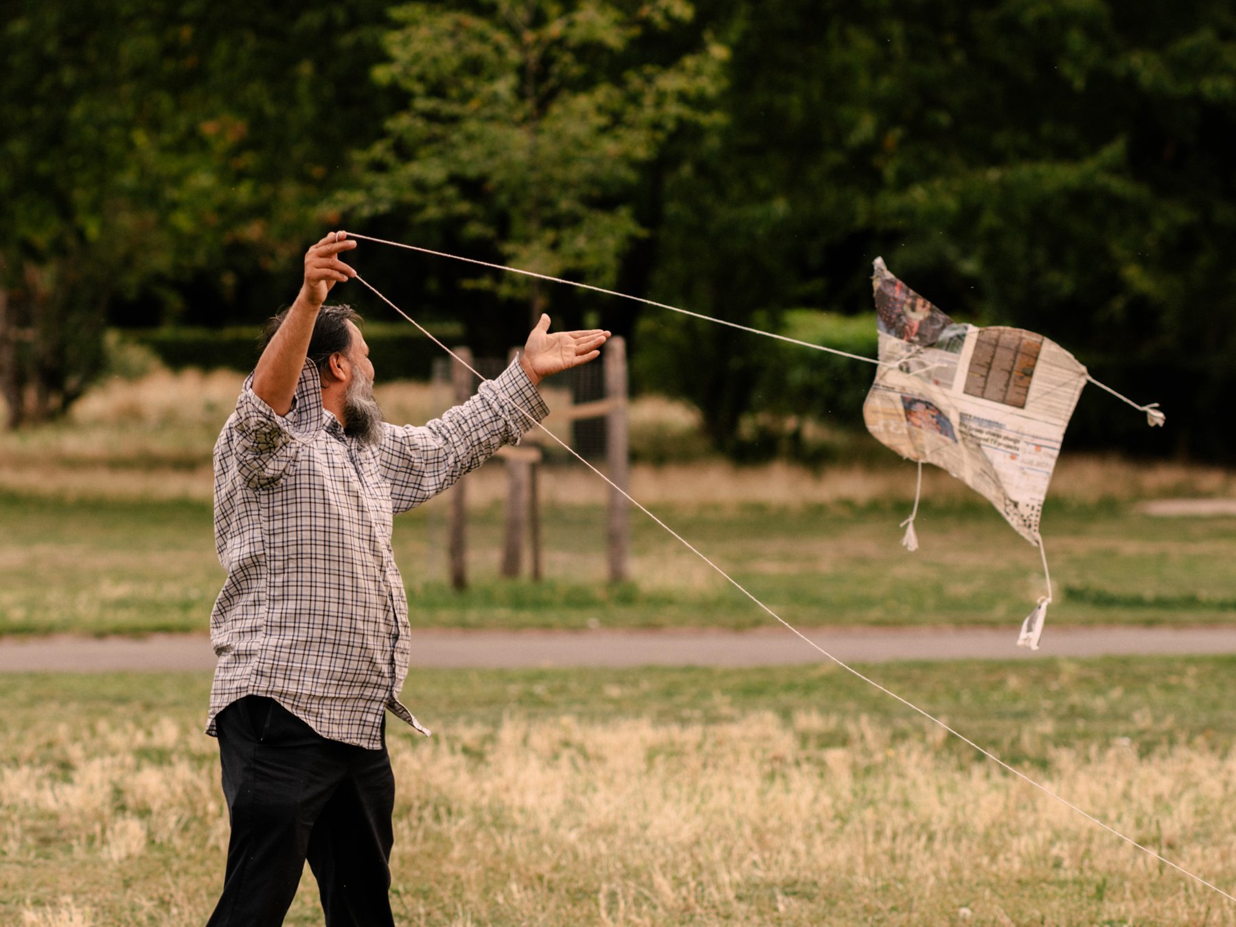 Man flying kite in East London park 