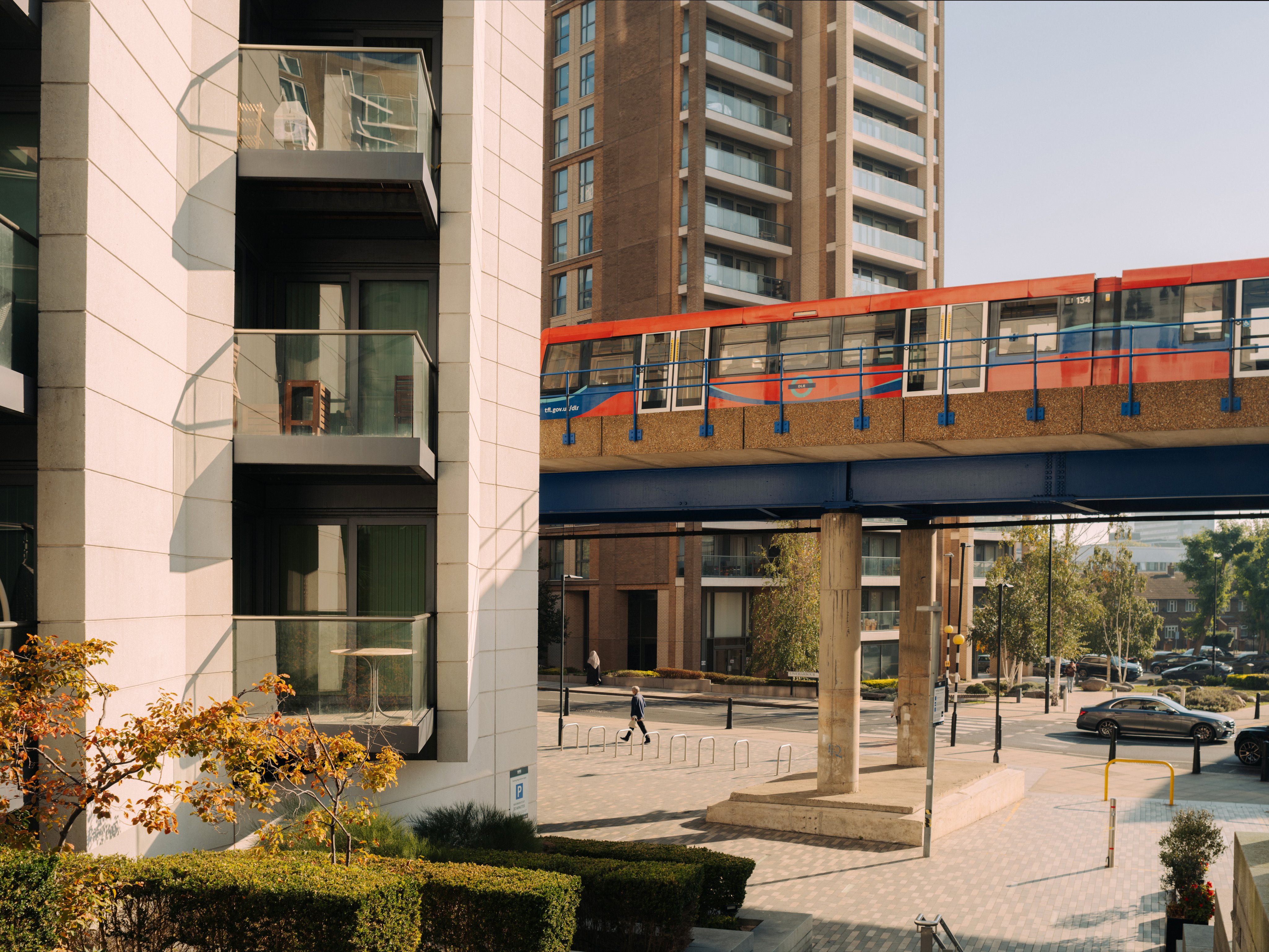 DLR train passing through neighbourhood of high rise flats.