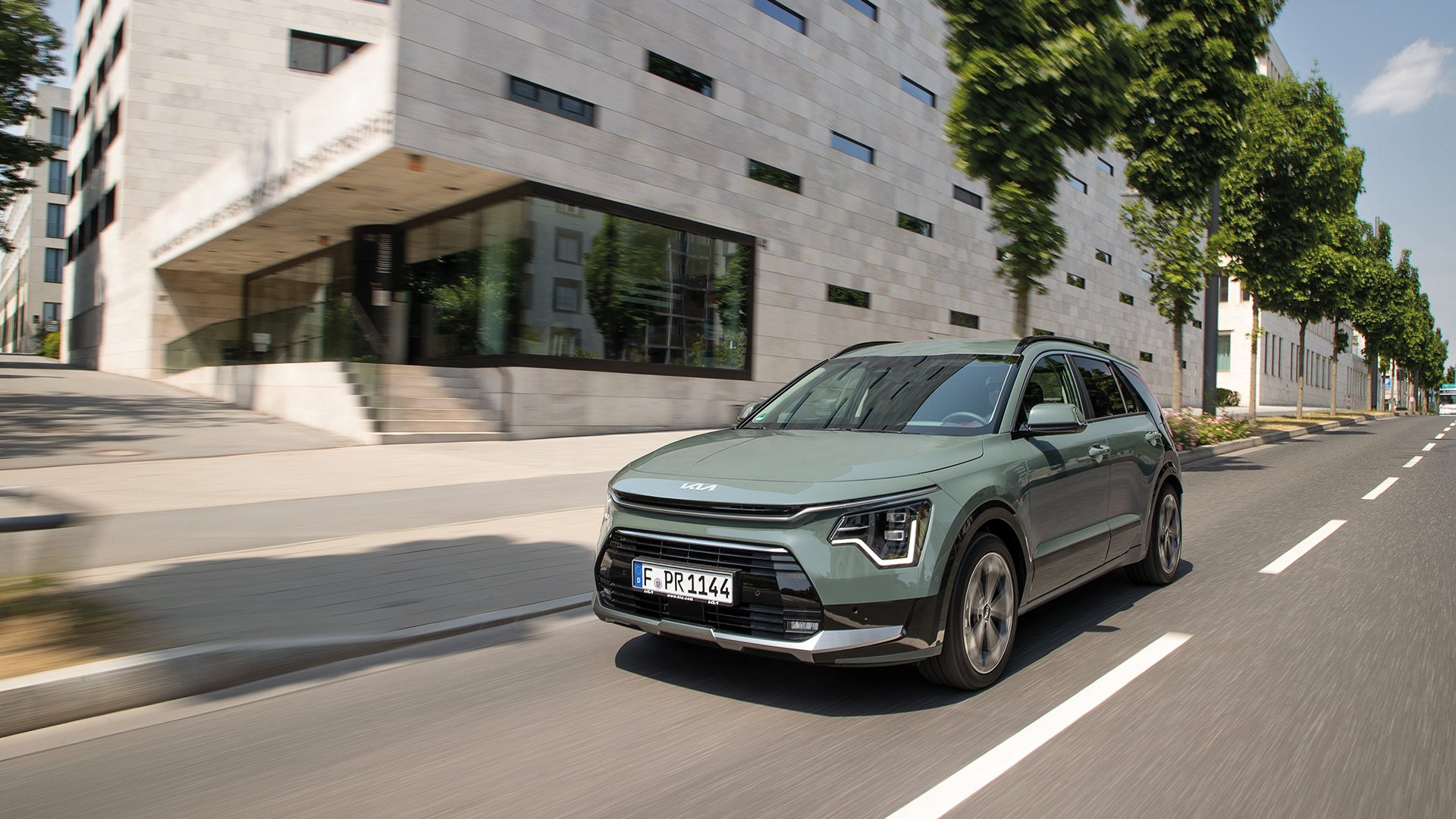 Kia Niro driving on a city street, front three-quarter view