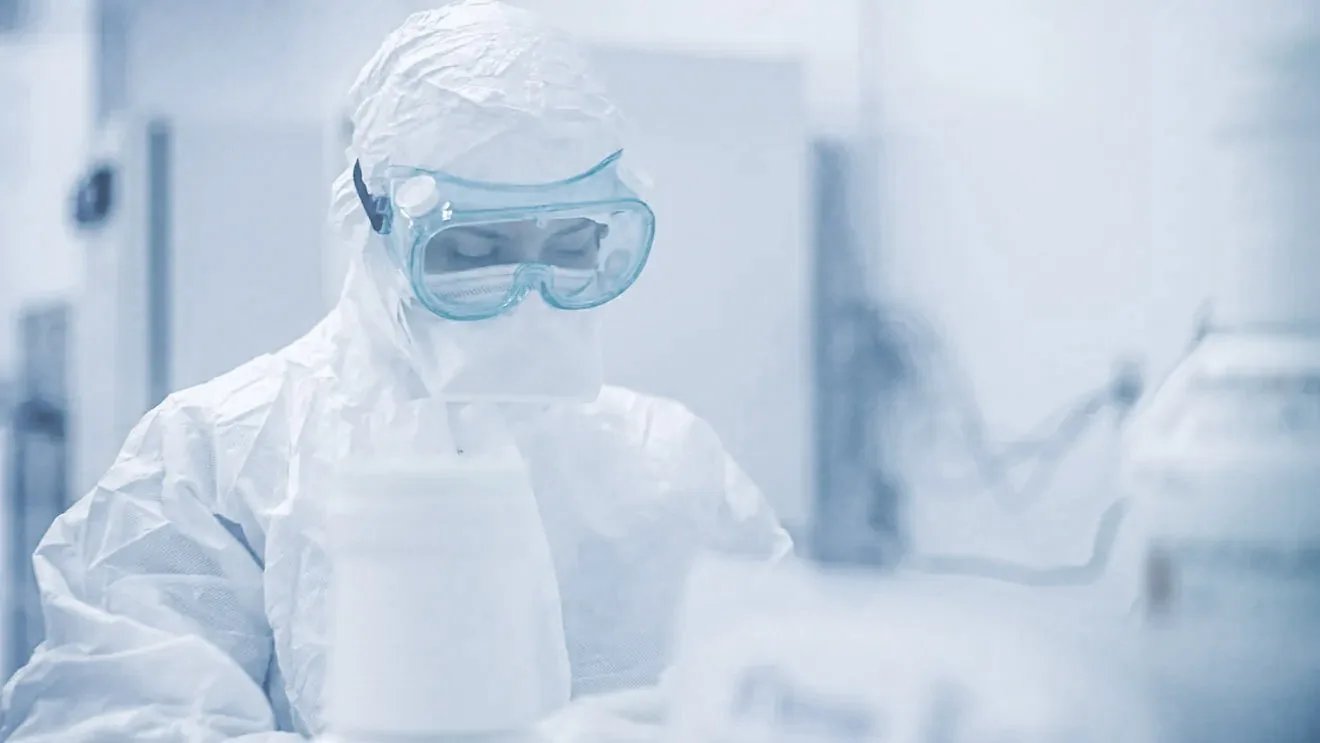 gowned lab tech