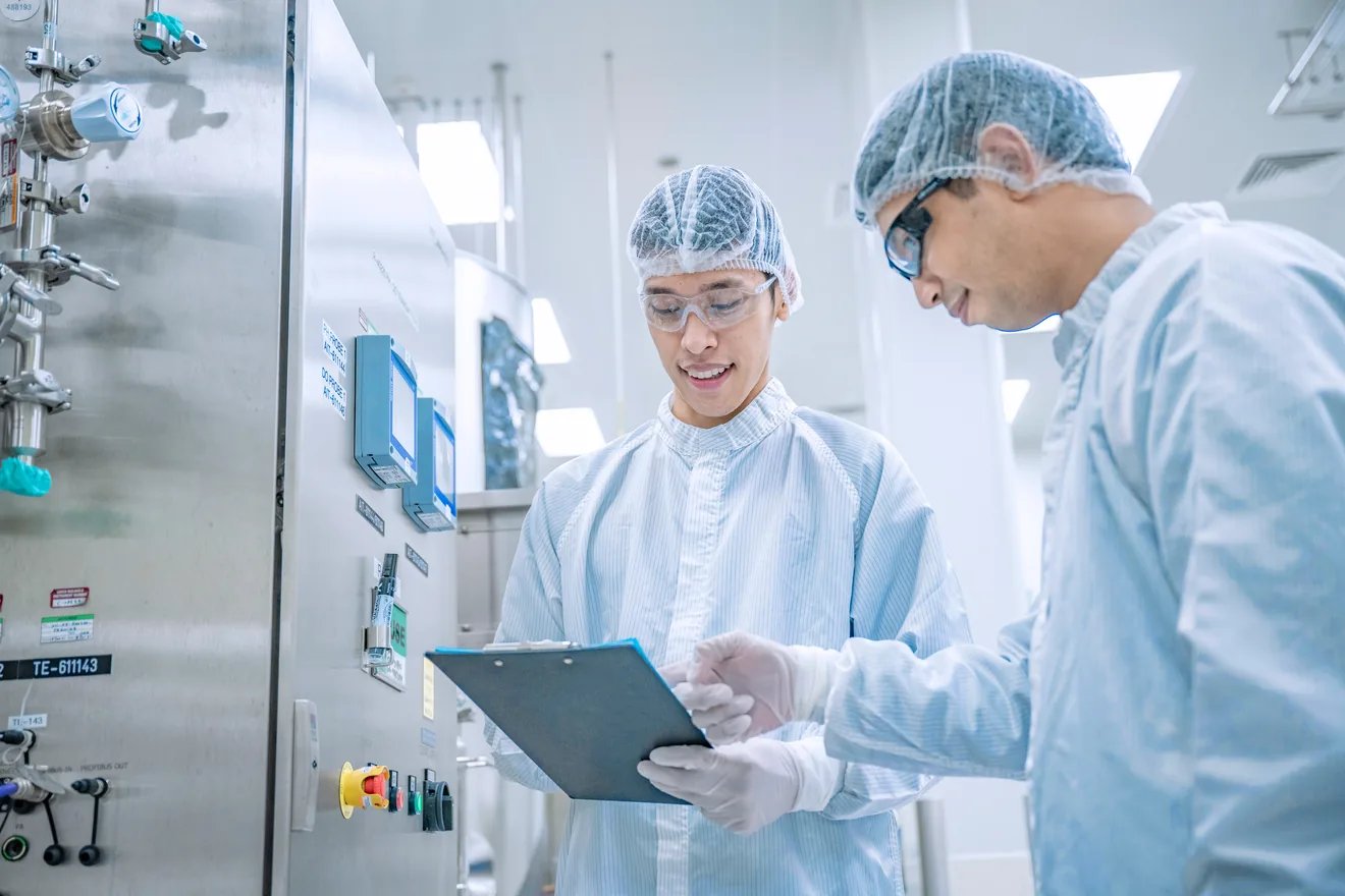 two lab techs reviewing paperwork 