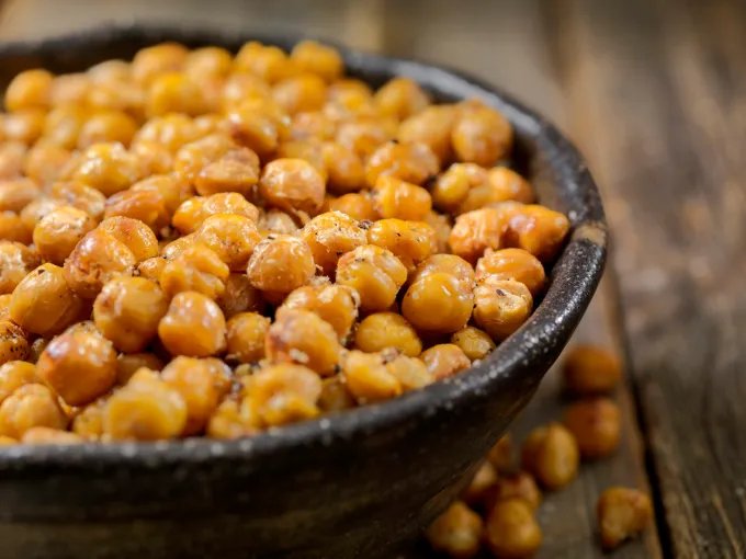A closeup of a bowl of roasted chickpeas