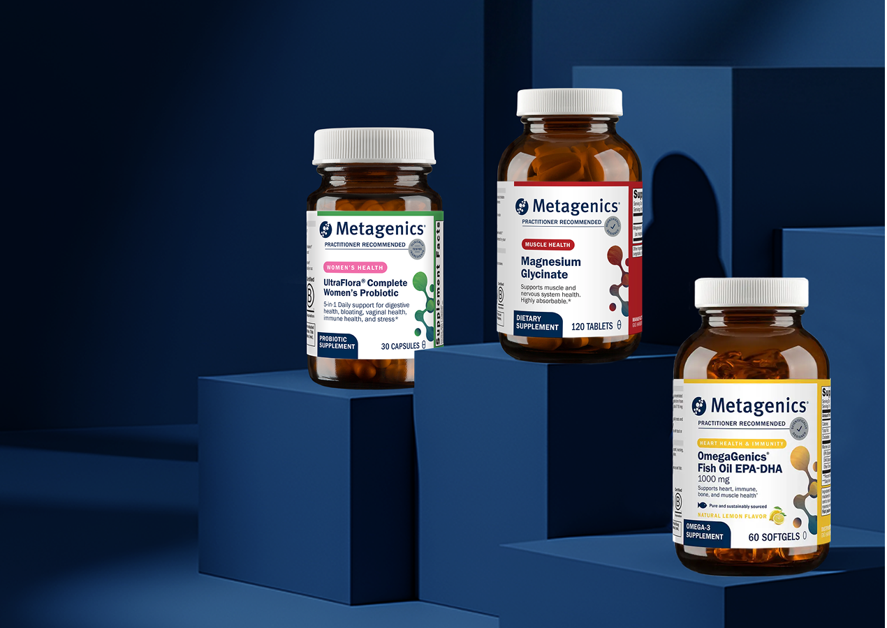 Hero image showing three Metagenics supplement bottles displayed on tiered blue platforms: UltraFlora® Complete Women's Probiotic, Magnesium Glycinate, and OmegaGenics® Fish Oil EPA-DHA. The clean, modern arrangement highlights foundational support for gut health, stress balance, and whole-body wellness, encouraging visitors to reset your routine during the new year supplement sale with Metagenics.